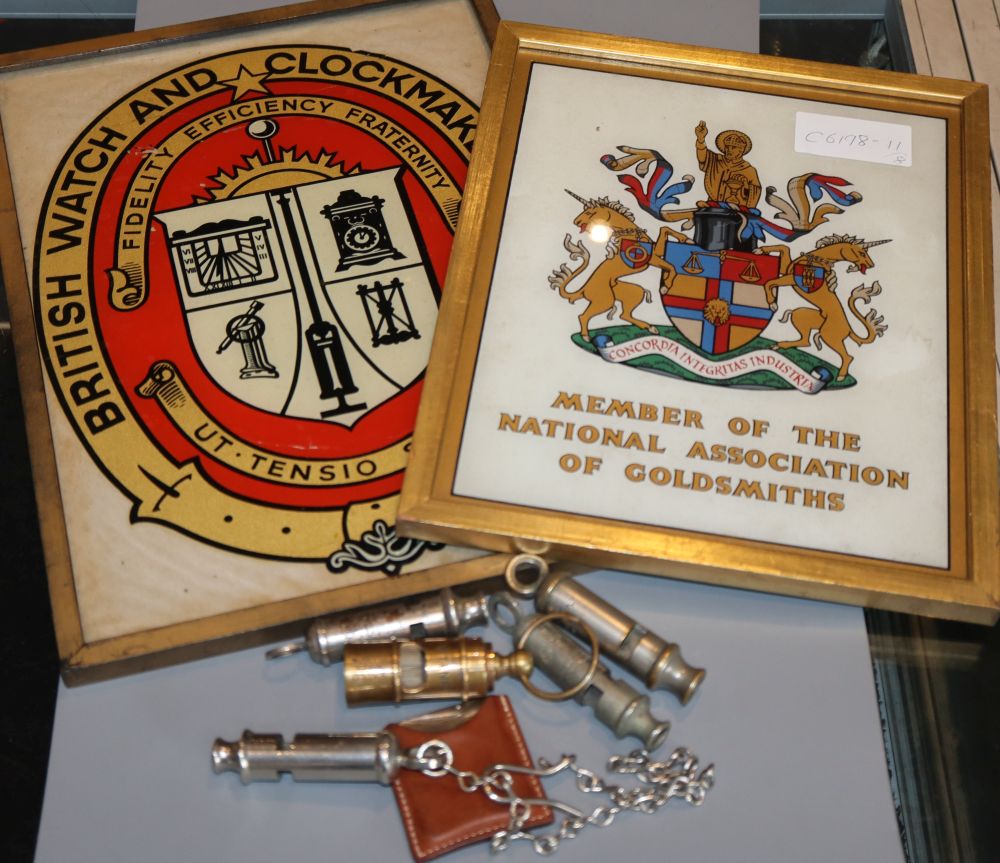 A Hermes cigar cutter, five whistles, A British Watch and Clockmakers Guild framed logo and Member of The National Association of Gold